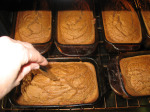 Checking pumpkin bread out of the oven