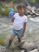 methods of water purification - standing in river with clean drinking water