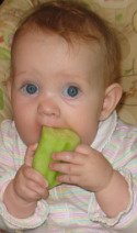 Baby eating cucumber