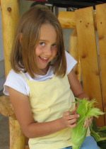 Child Shucking Corn Cobs